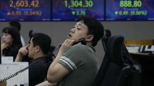 A currency trader watches monitors at the foreign exchange dealing room of the KEB Hana Bank headquarters in Seoul, South Korea, Tuesday, July 4, 2023. Asian stock markets were mixed Tuesday after Wall Street hit a 15-month high ahead of a decision by Australia's central bank on a possible interest rate hike. (AP Photo/Ahn Young-joon)