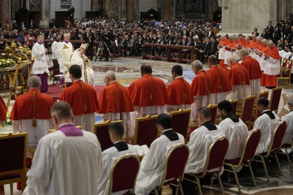 FILE - Pope Francis prays in front of new Cardinals during consistory inside St. Peter's Basilica, at the Vatican, Saturday, Aug. 27, 2022. Pope Francis has announced he has chosen 21 new cardinals, including prelates from Jerusalem and Hong Kong, places where Catholics are a small minority. The pope announced his picks during his customary appearance on Sunday, July 9, 2023 to the public in St. Peter’s Square, saying the ceremony to formally install the churchmen as cardinals will be held on Sept. 30. (AP Photo/Andrew Medichini, File)
