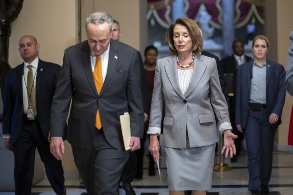 
              Speaker of the House Nancy Pelosi, D-Calif., and Senate Minority Leader Chuck Schumer, D-N.Y., left, walk to meet with furloughed federal workers and discuss the impact on families from the partial government shutdown amid President Donald Trump's demands for funding a U.S.-Mexico border wall, on Capitol Hill in Washington, Wednesday, Jan. 9, 2019. (AP Photo/J. Scott Applewhite)
            