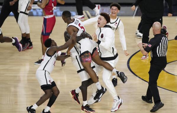 San Diego State guard Lamont Butler (5) celebrates with teammates after hitting the winning basket against Florida Atlantic during the second half of a Final Four college basketball game in the NCAA Tournament on Saturday, April 1, 2023, in Houston. (AP Photo/Godofredo A. Vasquez)