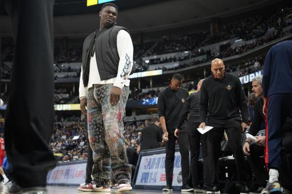 Injured New Orleans Pelicans forward Zion Williamson heads back to the bench after a timeout late in the second half of the team's NBA basketball game against the Denver Nuggets on Thursday, March 30, 2023, in Denver. (AP Photo/David Zalubowski)