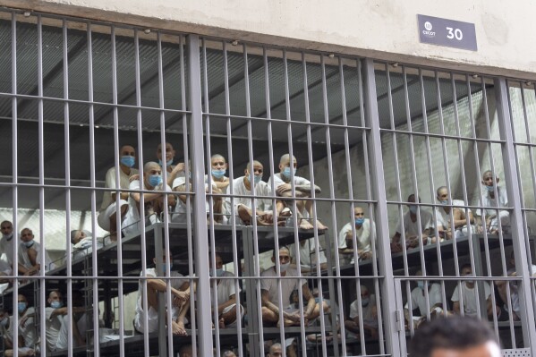 Prisoners look out of their cell as Homeland Security Secretary Kristi Noem tours the Terrorist Confinement Center in Tecoluca, El Salvador, March 26, 2025. (AP Photo/Alex Brandon, File)