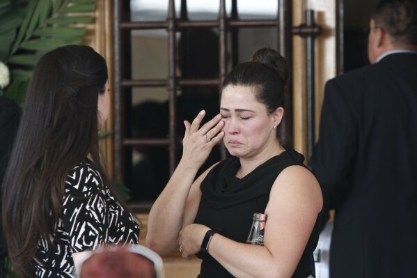 A woman cries at the funeral of elementary school principal Elsa Mendoza, of one of the 22 people killed in a shooting at a Walmart in El Paso, in Ciudad Juarez, Mexico, Thursday, Aug. 8, 2019. Mexican officials have said eight of the people killed in Saturday's attack were Mexican nationals. (AP Photo/Christian Chavez)