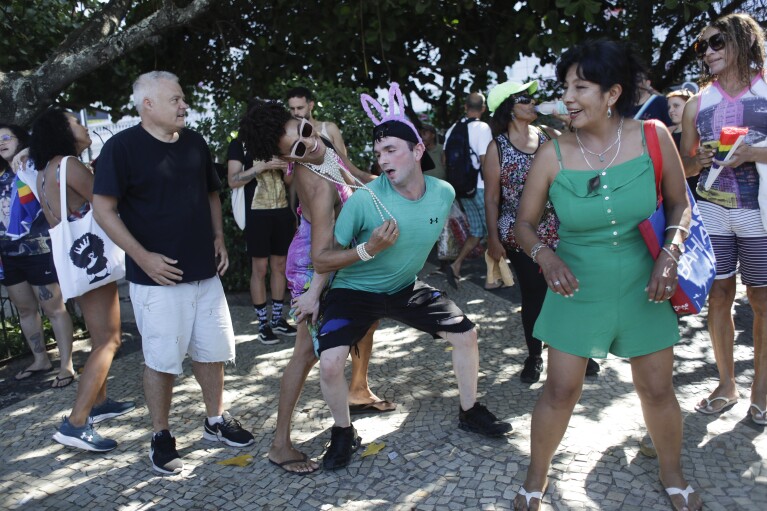 Madonna fans dance outside Copacabana Palace hotel where Madonna is staying ahead of her Celebration tour concert in Rio de Janeiro, Brazil, Friday, May 3, 2024. Madonna will conclude her tour on Saturday with a free concert at Copacabana Beach. (AP Photo/Bruna Prado