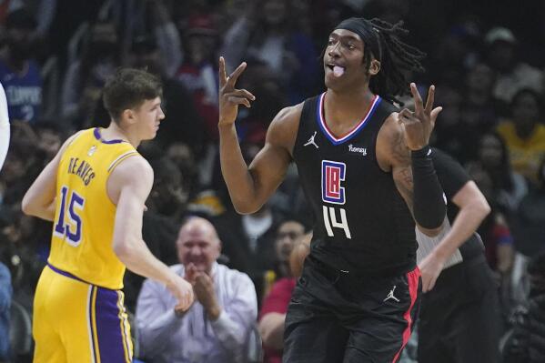 Los Angeles Clippers guard Terance Mann (14) reacts after making a 3-point basket during the first half of the team's NBA basketball game against the Los Angeles Lakers on Thursday, March 3, 2022, in Los Angeles. (AP Photo/Marcio Jose Sanchez)