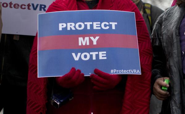 FILE - People wait in line outside the Supreme Court in Washington to listen to oral arguments in a voting rights case on Feb. 27, 2013. A U.S. Supreme Court decision a decade ago that tossed out the heart of the Voting Rights Act continues to reverberate across the country. Republican-led states continue to pass voting restrictions that, in several cases, would have been subject to federal review had the court left the provision intact. (AP Photo/Evan Vucci, File)