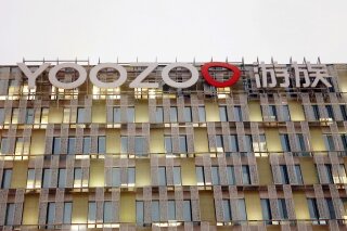 The Yoozoo logo is displayed at the Yoozoo group headquarters in Shanghai on Dec. 8, 2020. Police in Shanghai say a suspect has been detained in the death by possible poisoning of the billionaire founder of a Chinese video game company that is producing films based on popular science fiction novel “The Three-Body Problem.” Yoozoo Games said Lin Qi, 39, died on Christmas Day after being hospitalized. (Chinatopix via AP)