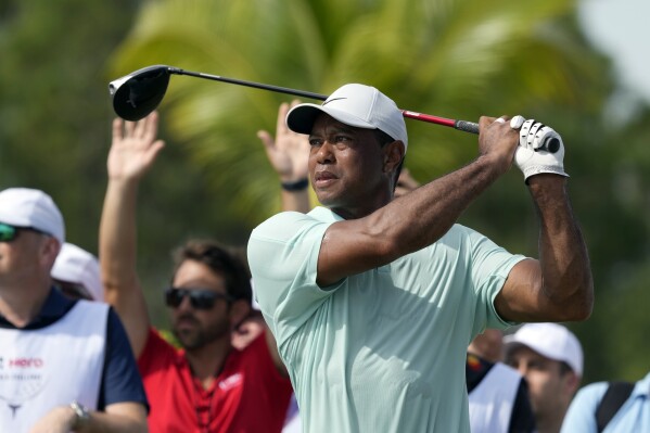 FILE - Tiger Woods watches his shot on the fourth tee during the third round of the Hero APChallenge PGA Tour at the Albany Golf Club, in New Providence, Bahamas, Saturday, Dec. 2, 2023. Tiger Woods confirmed Wednesday, Feb. 7, 2024 he will make his first PGA Tour start since the Masters at the Genesis Invitational next week at Riviera, a tournament he hosts. (APPhoto/Fernando Llano, File)