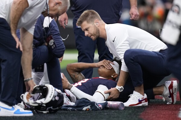 Houston Texans wide receiver Tank Dell is attended to after being injured in the first half of an NFL football game against the Denver Broncos Sunday, Dec. 3, 2023, in Houston. (AP Photo/Eric Gay)