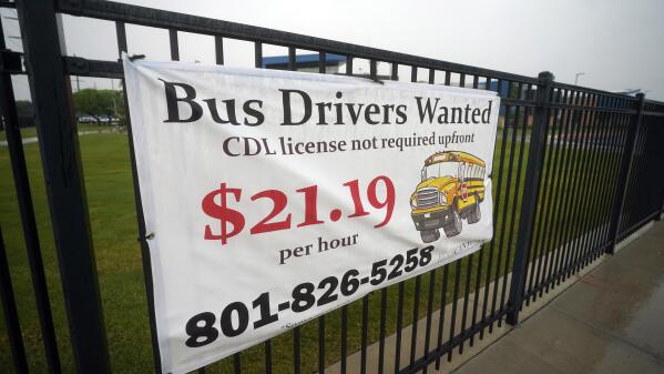 A "Bus Drivers Wanted" sign is shown Wednesday, Aug. 18, 2021, in Sandy, Utah. A shortage of bus drivers is complicating the start of a new school year already facing a surge in COVID-19 cases and conflicts over whether masks should be required in school buildings. (AP Photo/Rick Bowmer)