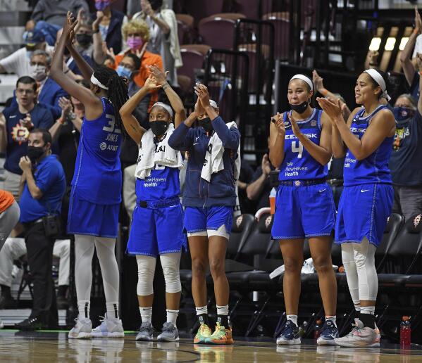 Connecticut Sun players on the bench applaud as time expires on their win over the Atlanta Dream in a WNBA basketball game Sunday, Sept. 19, 2021, in Uncasville, Conn. (Sean D. Elliot/The Day via AP)