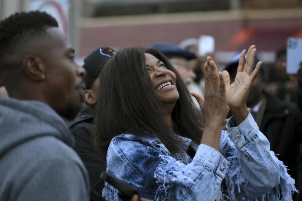 Angela Harrelson, aunt of George Floyd, reacts after the unveiling of a George Perry Floyd sign Wednesday, May 25, 2022, in Minneapolis. The intersection where Floyd died at the hands of Minneapolis police officers was renamed in his honor Wednesday, among a series of events to remember a man whose killing forced America to confront racial injustice. (Aaron Lavinsky/Star Tribune via AP)