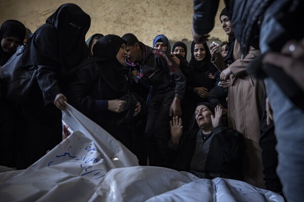 Members of the Abu Sinjar family mourn their relatives killed in the Israeli bombardment of the Gaza Strip at their house in Rafah, southern Gaza, Friday, Jan. 5, 2024. (AP Photo/Fatima Shbair)