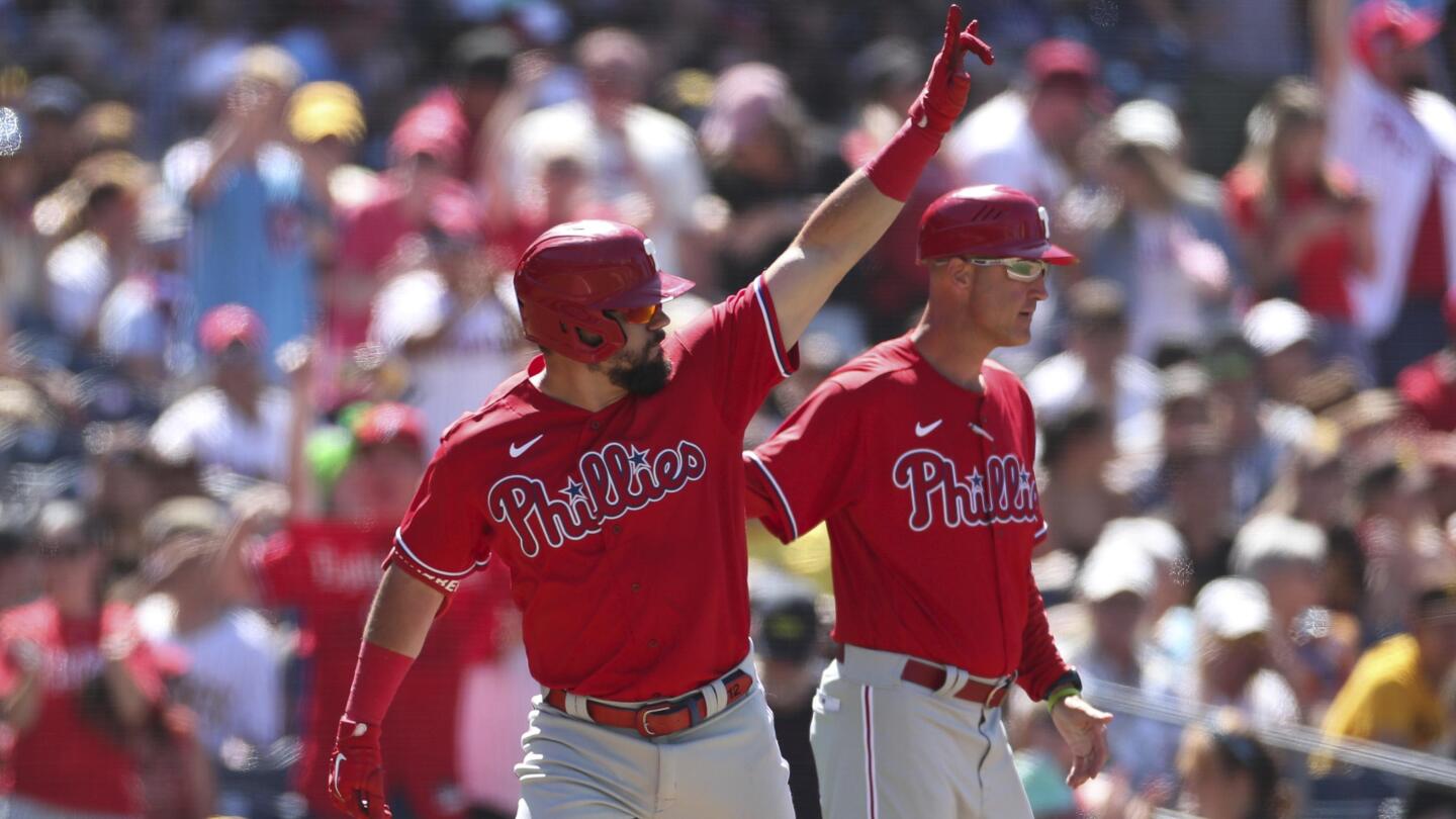 Philadelphia Phillies' Kyle Schwarber, background center, celebrates with  Matt Vierling (19) and Bryson Stott (5) after hitting a three run home run  against San Diego Padres' Nabil Crismatt in the seventh inning