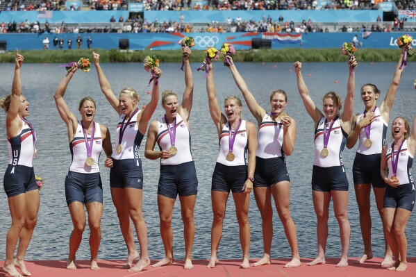 FILE - U.S. rowers Mary Whipple, Caryn Davies, Caroline Lind, Eleanor Logan, Meghan Musnicki, Taylor Ritzel, Esther Lofgren, Zsuzsanna Francia, and Erin Cafaro celebrate after winning the gold medal for the women's rowing eight in Eton Dorney, near Windsor, England, at the 2012 Summer Olympics, Thursday, Aug. 2, 2012. The U.S. women's eight went undefeated from 2006-17 in major international rowing championships, during which time they won three Olympic titles (2008, 2012 and 2016) and gold at eight straight world championships from 2006-15. (ĢӰԺ Photo/Natacha Pisarenko), File)