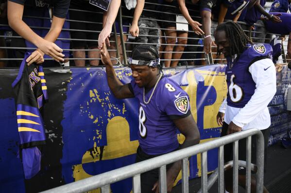 Baltimore Ravens quarterback Lamar Jackson, left, and linebacker Josh Bynes head to the lockers after watching their teammates workout prior to an NFL football game against the Tennessee Titans, Thursday, Aug. 11, 2022, in Baltimore. (AP Photo/Nick Wass)