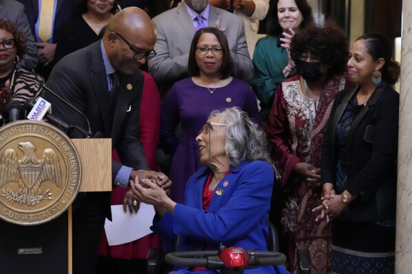Former Mississippi State Rep. Alyce Clarke, D-Jackson, right, is congratulated by State Rep. Robert Johnson, D-Natchez, following his comments at the ceremony where Clarke's official portrait was unveiled at the Mississippi State Capitol, Tuesday, Feb. 13, 2024, in Jackson. Clarke, a long-time legislator, is the first woman and the first African American to have a portrait displayed in the state Capitol. (AP Photo/Rogelio V. Solis)