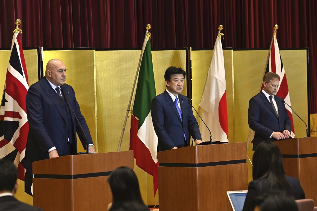 FILE - Britain's Defense Minister Grant Shapps, right, Italy's Defense Minister Guido Crosetto, left, and Japanese Defense Minister Minoru Kihara, center, attend a joint press conference after a signing ceremony for Global Combat Air Programme (GCAP) at the defense ministry on Dec. 14, 2023, in Tokyo, Japan. Japan’s Cabinet on Tuesday, March 26, 2024, approved a plan to sell future next-generation fighter jets that it’s developing with Britain and Italy to other countries, in the latest move away from the country’s postwar pacifist principles. (David Mareuil/Pool Photo via AP, File)
