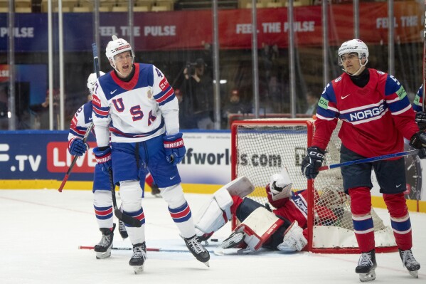 USA's Michael McCarron, front left, reacts after scoring his side's fourth goal during the group B match between USA and Norway at the IIHF Ice Hockey World Championships in Herning, Denmark, Wednesday, May 14, 2025. (Bo Amstrup/Ritzau Scanpix via AP)