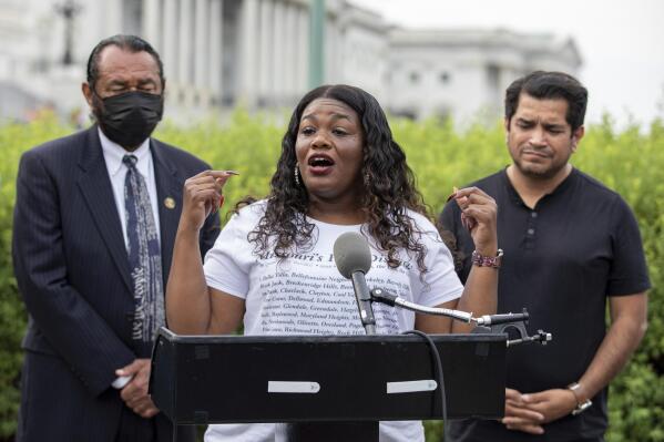 FILE - In this Aug. 3, 2021, file photo Rep. Cori Bush, D-Mo., flanked by Rep. Al Green, D-Texas, left, and Rep. Jimmy Gomez, D-Calif., right, speaks to the press after it was announced that the Biden administration will enact a targeted nationwide eviction moratorium outside of Capitol Hill in Washington. Several progressive lawmakers, including Bush, on Tuesday, Sept. 21, introduced a bill that would reimpose a nationwide eviction moratorium at a time when deaths from COVID-19 are running at their highest levels since early March. (AP Photo/Amanda Andrade-Rhoades, File)