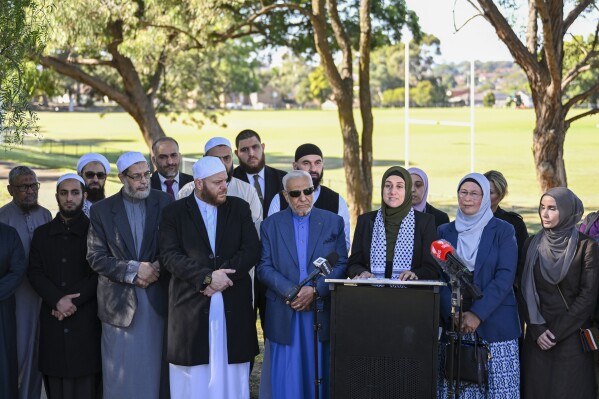 Ramia Abdo Sultan, lawyer and communications relations advisor of the Australian National Imams Council with Imams speaks during a press conference, in Sydney, Friday, April 26, 2024. Muslim groups in Australia on Friday criticized the disparity in the police response to two stabbing attacks in Sydney this month, saying it had created a perception of a double standard and further alienated the country's minority Muslim community. (Dean Lewins/AAP Image via AP)