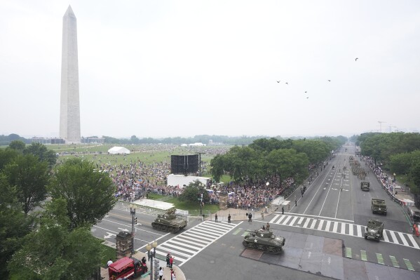A military parade commemorating the Army's 250th anniversary and coinciding with President Donald Trump's 79th birthday, Saturday, June 14, 2025, in Washington. The Washington Monument stands left. (AP Photo/Jacquelyn Martin)