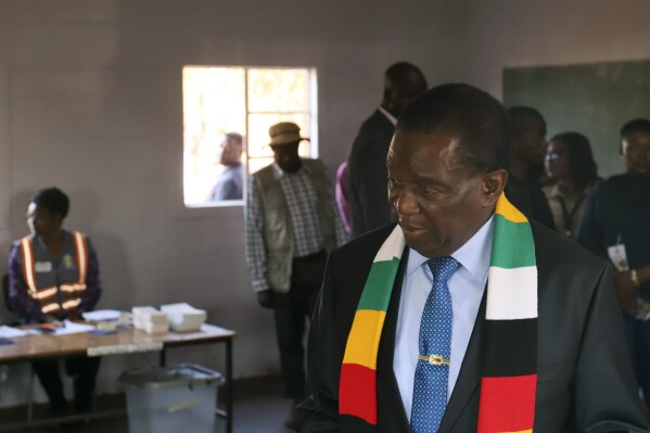 Zimbabwean President Emmerson Mnangagwa attends a polling station to cast his vote, in Kwekwe, Zimbabwe, Wednesday, Aug. 23, 2023. Polls have opened in Zimbabwe as President Emmerson Mnangagwa seeks a second and final term in a country with a history of violent and disputed votes. (AP Photo)