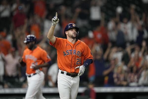 Houston Astros' Chas McCormick (20) celebrates as Yordan Alvarez, rear, scores the game-winning run after McCormick was hit with a pitch with the bases loaded during the 10th inning of a baseball game against the Arizona Diamondbacks Friday, Sept. 17, 2021, in Houston. The Astros won 4-3 in 10 innings. (AP Photo/David J. Phillip)