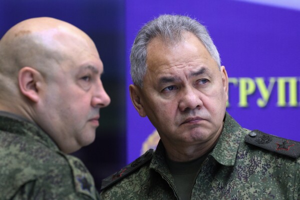 FILE - The top Russian military commander in Ukraine, Gen. Sergei Surovikin, left, and Russian Defense Minister Sergei Shoigu attend a meeting at an unknown location on Dec. 17, 2022, with President Vladimir Putin during his visit to troops fighting in Ukraine. Surovikin, who reportedly had close ties with Russian mercenary chief Yevgeny Prigozhin, was stripped of his post as deputy commander of forces in Ukraine after the brief uprising by Prigozhin on June 23-24, 2023. (Gavriil Grigorov, Sputnik, Kremlin Pool Photo via AP, File)