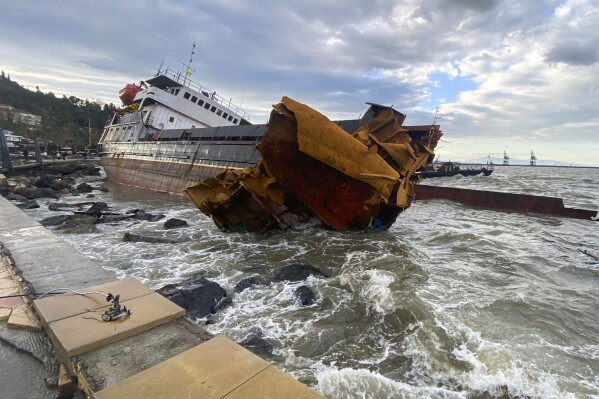 A view of a Cameroon-flagged Pallada rests among rocks at the sea shore in Eregli, Turkey, Monday, Nov. 20, 2023. The Cameroon-flagged Pallada broke into two due to heavy weather conditions after running aground in 5-meter (16-foot) waves off Eregli, the Maritime General Directorate said. All 13 crew were rescued safely (IHA via AP)