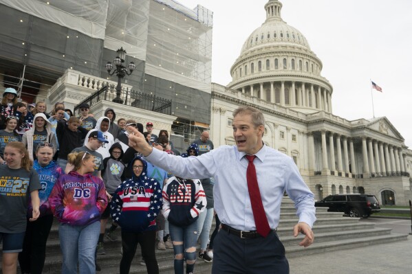 FILE - Rep. Jim Jordan, R-Ohio, greets 8th-grade students and parents from Bath Middle School of Lima, Ohio, as rain begins to fall on Capitol Hill in Washington, Friday, May 10, 2019. (AP Photo/J. Scott Applewhite, File)