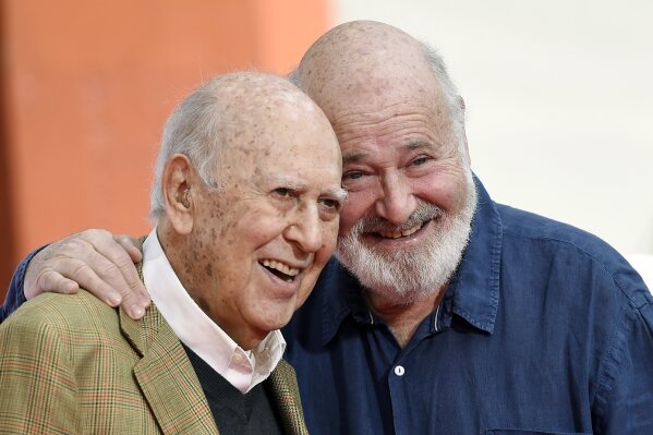 FILE - In this April 7, 2017 file photo, Carl Reiner, left, and his son Rob Reiner pose together following their hand and footprint ceremony at the TCL Chinese Theatre in Los Angeles. Carl Reiner, the ingenious and versatile writer, actor and director who broke through as a “second banana” to Sid Caesar and rose to comedy’s front ranks as creator of “The Dick Van Dyke Show” and straight man to Mel Brooks’ “2000 Year Old Man,” has died, according to reports. Variety reported he died of natural causes on Monday night, June 29, 2020, at his home in Beverly Hills, Calif. He was 98. (Photo by Chris Pizzello/Invision/AP, File)
