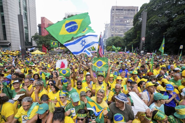 Followers of former Brazilian President Jair Bolsonaro rally to express their support for him in Sao Paulo., Brazil, Sunday, Feb. 25, 2024. Bolsonaro and some of his former top aides are under investigation into allegations they plotted a coup to remove his successor, Luis Inacio Lula da Silva. (AP Photo/Andre Penner)