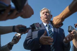 FILE - In this Tuesday, July 13, 2021, file photo, Missouri Gov. Mike Parson answers media's questions in Kansas City, Mo. Parson on Thursday, Oct, 14, 2021 condemned the St. Louis Post-Dispatch newspaper for exposing a flaw in a state database that allowed public access to thousands of teachers' Social Security numbers, even though the paper held off from reporting about the flaw until after the state could fix it. (Shelly Yang/The Kansas City Star via AP, File)