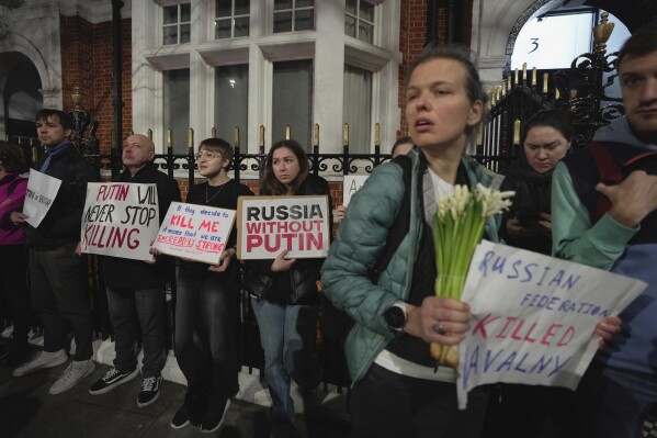 Protesters stage a demonstration opposite the Russian Embassy in London, Friday, Feb. 16, 2024, in reaction to the news that jailed Russian opposition leader Alexei Navalny has died in a Russian prison, according to the Federal Penitentiary Service. (AP Photo/Kin Cheung)