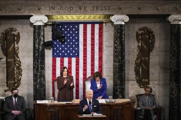 President Joe Biden delivers his first State of the Union address to a joint session of Congress at the Capitol, Tuesday, March 1, 2022, in Washington as Vice President Kamala Harris applauds and House speaker Nancy Pelosi of Calif., looks on. (Sarahbeth Maney/The New York Times via AP, Pool)