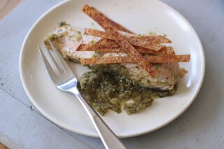 Salmon poached in green salsa and topped with baked chips are displayed for a photo in Concord, N.H. (AP Photo/Matthew Mead, File)