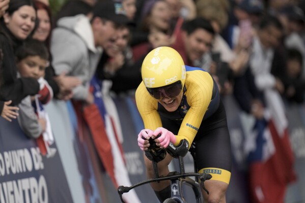 FILE - Ecuador's Richard Carapaz pedals in the men's individual time trial final at the Pan American Games in Isla de Maipo, Chile, Oct. 22, 2023. Carapaz will not be at the Paris Olympics in 2024 to defend his road cycling gold medal. (AP Photo/Eduardo Verdugo, File)