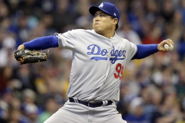 FILE - Los Angeles Dodgers starting pitcher Hyun-Jin Ryu throws to the Milwaukee Brewers during the first inning of a baseball game on April 20, 2019, in Milwaukee. Pitcher Hyun Jin Ryu looks set to return to South Korea after 10 years in Major League Baseball, South Korean media reported. (AP Photo/Jeffrey Phelps, File)