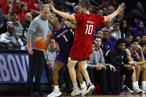 Northwestern guard Chase Audige (1) is fouled by Rutgers guard Cam Spencer (10) during the second half of an NCAA college basketball game, Sunday, Mar.5, 2023, in Piscataway, N.J. Northwestern won 65-53. (AP Photo/Noah K. Murray)