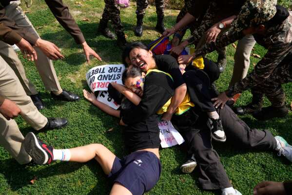 Police try to detain protesting Tibetan exiles during a protest outside Chinese embassy to mark the 1959 uprising in Tibet against the Chinese rule on this day, in New Delhi,India, Monday, March, 10, 2025. (AP Photo/Manish Swarup)