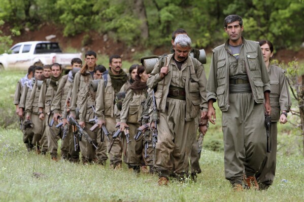 A group of armed Kurdish fighters from the Kurdistan Workers Party (PKK) enter northern Iraq in the Heror area, northeast of Dahuk, 260 miles (430 kilometers) northwest of Baghdad, Iraq, May 14, 2013. (AP Photo/Ceerwan Aziz, File)