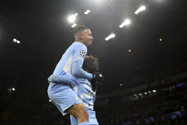 Manchester City's Gabriel Jesus, top, celebrates scoring his side's second goal during the Champions League group A soccer match between Manchester City and Paris Saint-Germain at the Etihad Stadium in Manchester, England, Wednesday, Nov. 24, 2021. (AP Photo/Scott Heppell)