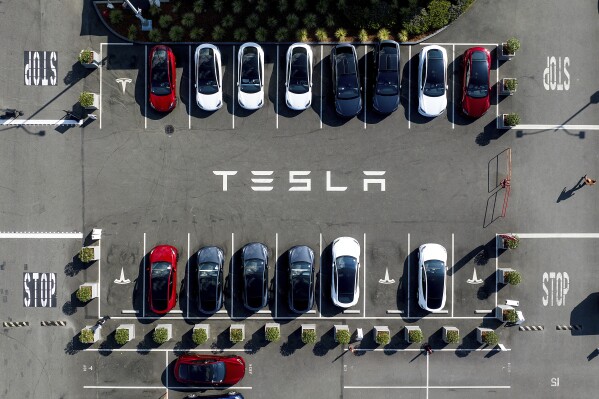 FILE - Tesla vehicles line a parking lot at the company's Fremont, Calif., factory, on Sept. 18, 2023. Pressure mounts on Tesla to sign a Swedish collective bargaining agreement. The car painters’ union in Sweden on Friday, Nov. 10, 2023 said it will not allow its members to carry out any work on the electric vehicles. Members of the powerful metalworkers’ union IF Metall strike because Tesla’s Swedish subsidiary “have refused to sign a collective agreement and violate basic principles in the Swedish labor market,” saying such deal is “the backbone of the Swedish model.” (AP Photo/Noah Berger, File)