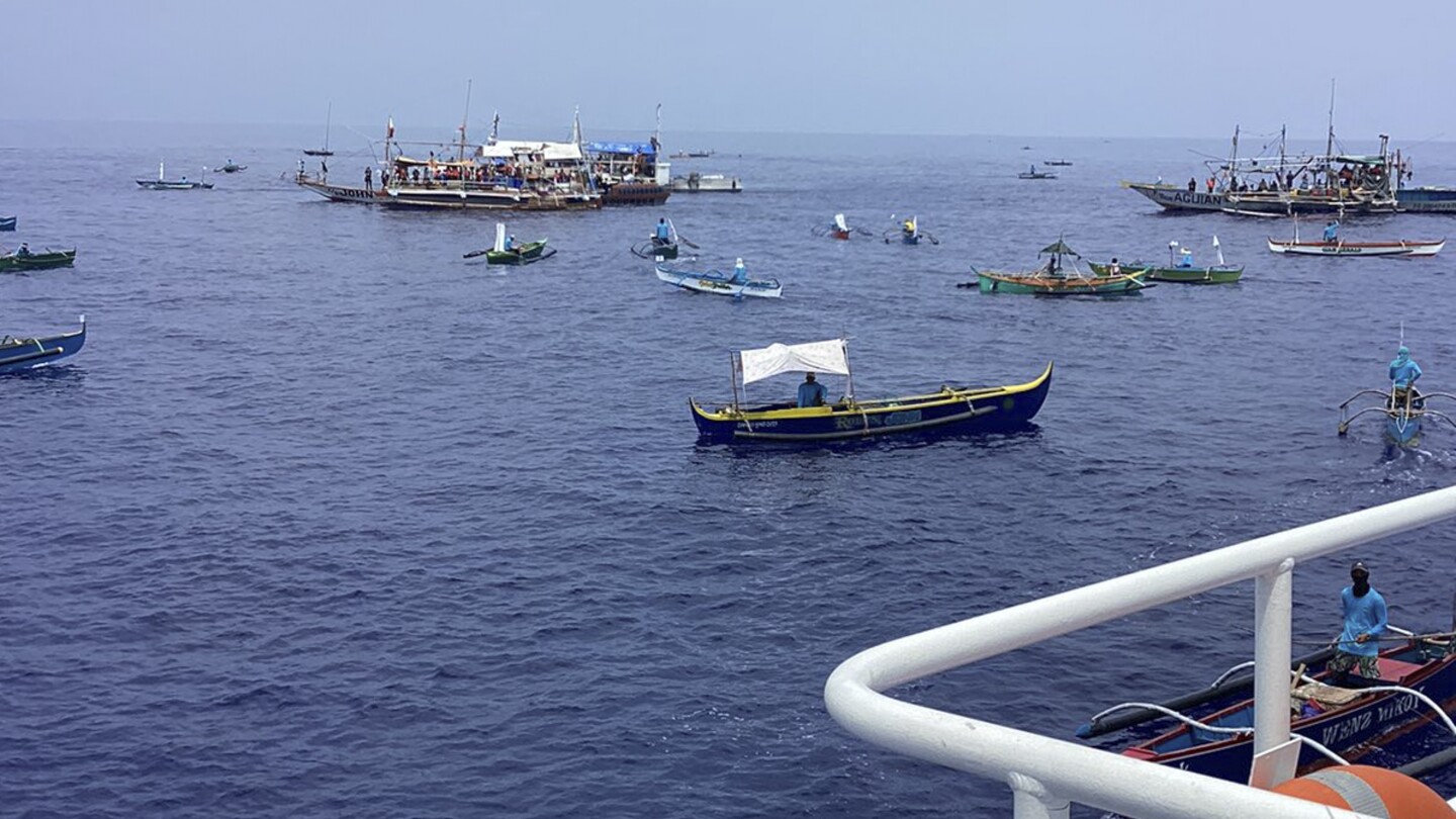 South China Sea: Filipino activists and fishermen sail a flotilla of 100 boats into disputed shoals