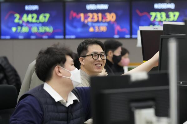 Currency traders watch monitors at the foreign exchange dealing room of the KEB Hana Bank headquarters in Seoul, South Korea, Tuesday, Jan. 31, 2023. Asian shares mostly fell in muted trading Tuesday as investors awaited decisions on interest rates and earnings reports from around the world. (AP Photo/Ahn Young-joon)