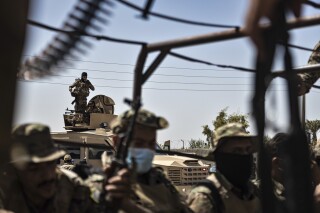U.S.-backed Syrian Democratic Forces (SDF) fighters sit on their armored vehicles, at al-Sabha town in the eastern countryside of Deir el-Zour, Syria, Monday, Sept. 4, 2023. Weeklong clashes between rival U.S.-backed militias in eastern Syria, where hundreds of American troops are deployed, point to dangerous seams in a coalition that has kept on a lid on the defeated Islamic State group for years. (AP Photo/Baderkhan Ahmad)