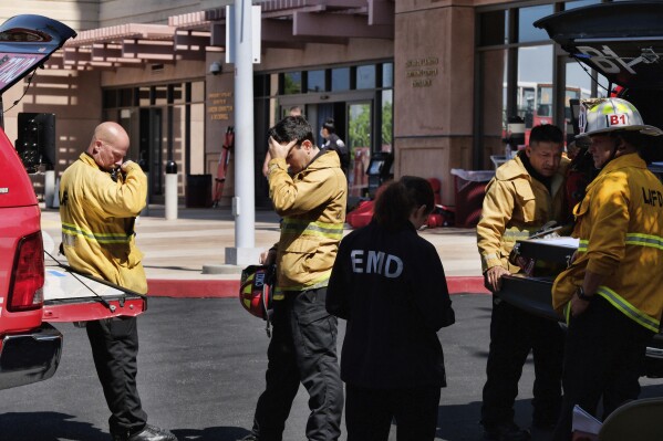 Los Angeles Fire Department personnel standby outside the White Memorial Medical Center in Los Angeles on Tuesday, Aug. 22, 2023. A succession of power outages at a Los Angeles hospital prompted the evacuation of 28 patients in critical condition to other hospitals early Tuesday, while 213 other patients were moved to another building in the medical center, authorities said. (AP Photo/Richard Vogel)