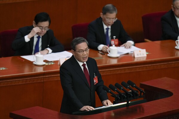 Chinese Premier Li Qiang deliver his opening speech during the opening session of the National People's Congress (NPC) at the Great Hall of the People in Beijing, China, Tuesday, March 5, 2024. (AP Photo/Andy Wong)