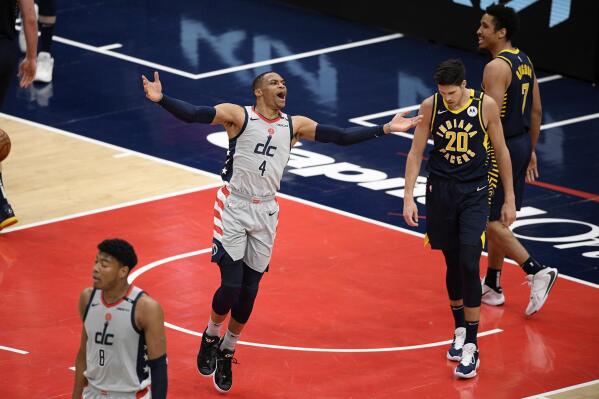 Washington Wizards guard Russell Westbrook (4) reacts next to Indiana Pacers forward Doug McDermott (20) and guard Malcolm Brogdon (7) during the second half of an NBA basketball Eastern Conference play-in game Thursday, May 20, 2021, in Washington. (AP Photo/Nick Wass)